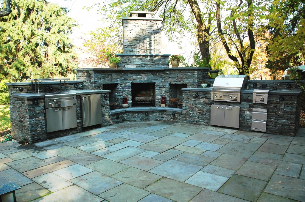 outdoor patio kitchen and stone custom fire place with chimney- Amazing Deck